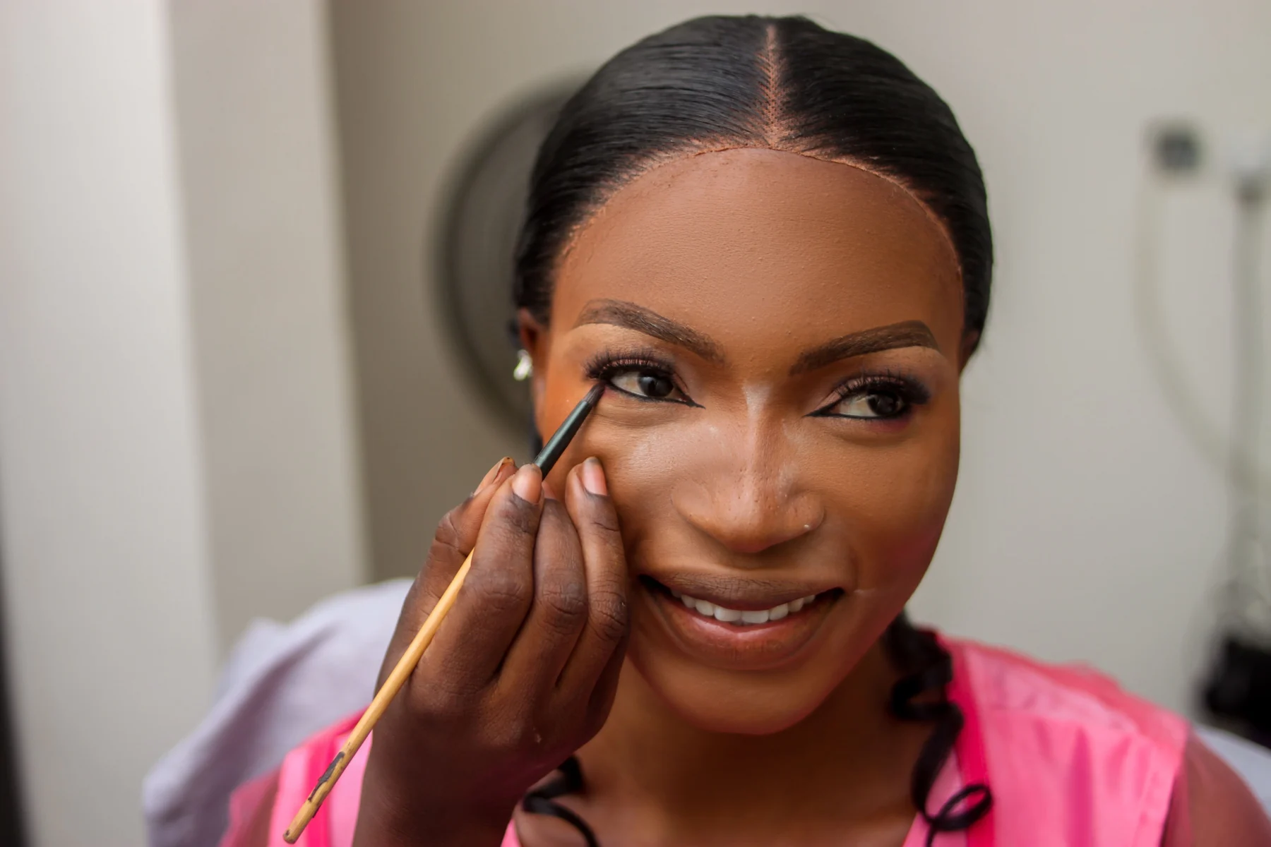 Nigerian bride having makeup applied